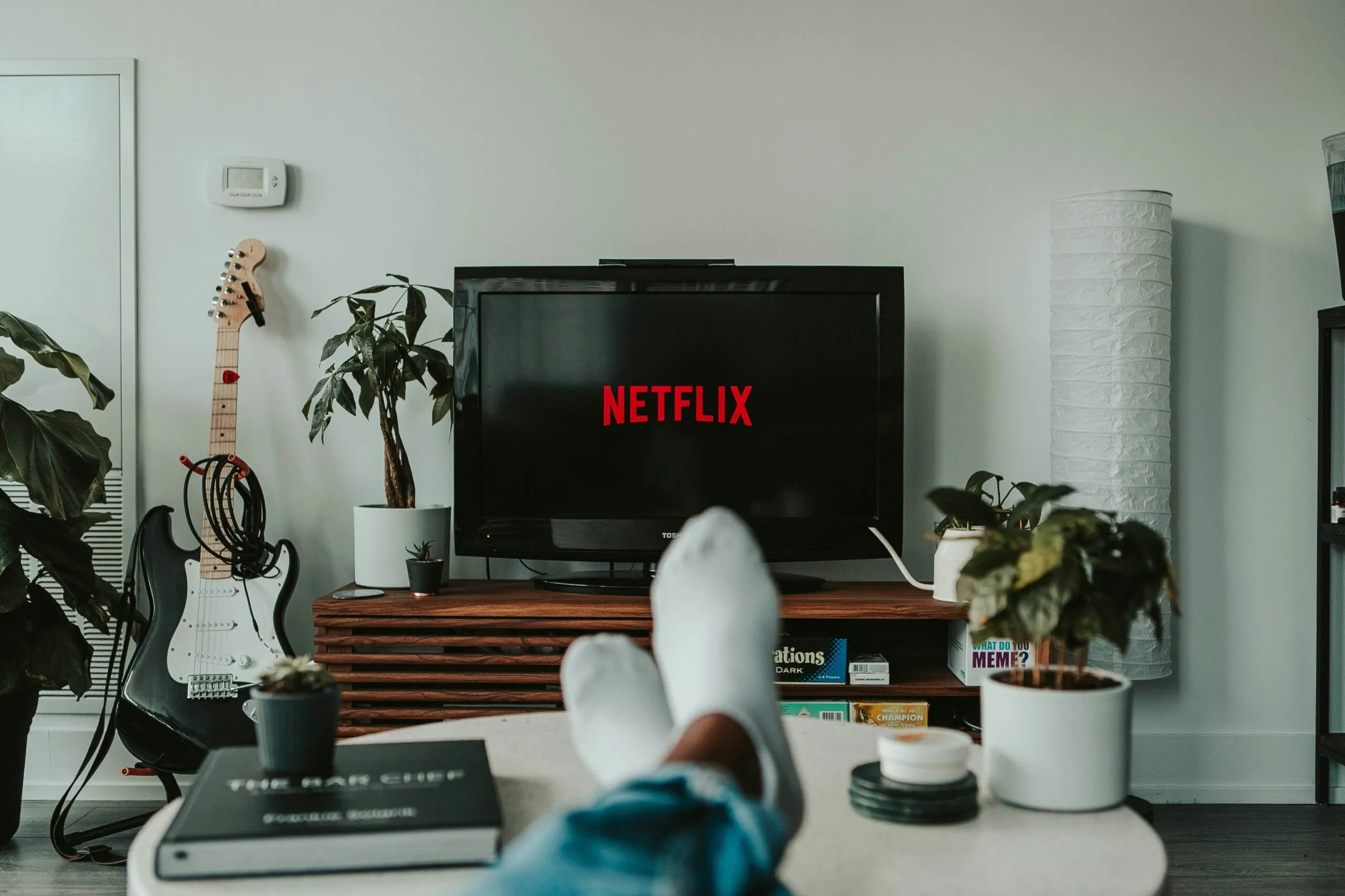 person relaxes while watching Netflix in a well decorated living room
