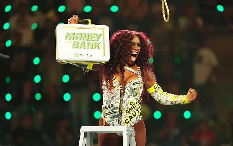 Naomi celebrates winning the Briefcase during WWE Money in the Bank
