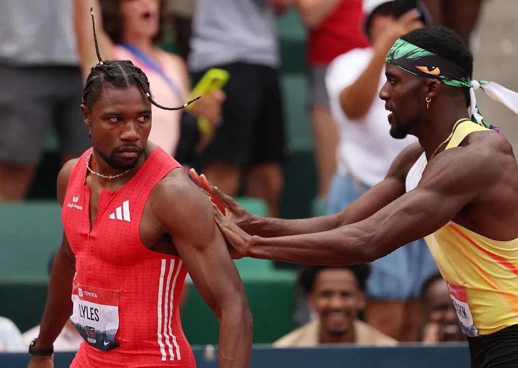Noah Lyles is pushed by Kenny Bednarek following the Xfinity Men's 200m final during the 2025 USATF Outdoor Championships