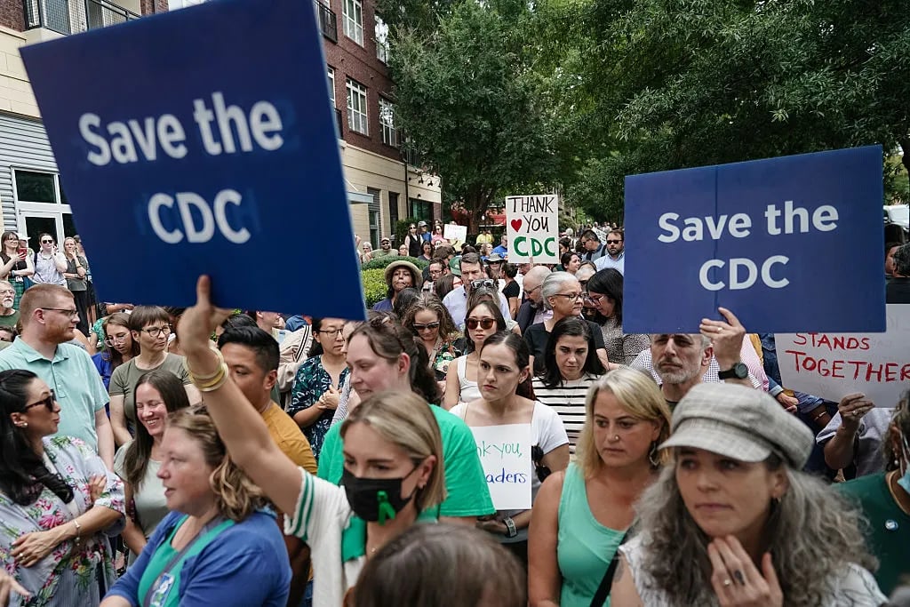 ATLANTA, GEORGIA - AUGUST 28: Employees and supporters of the Centers for Disease Control (CDC) hold signs and clap and cheer to honor former Centers for Disease Control (CDC) officials Dan Jernigan, Deb Houry, and Demetre Daskalakis outside its global headquarters on August 28, 2025 in Atlanta, Georgia. The three officials were honored after resigning in the wake of U.S. President Donald Trump's attempted firing of CDC director Susan Monarez..