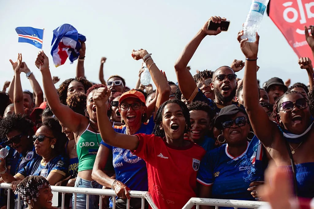 Supporters react during the FIFA World Cup 2026 Africa qualifiers group D match between Cape Verde and Eswatini at a fan zone in Sao Vicente, Cape Verde, on October 13, 2025. A carnival-like atmosphere erupted in the streets of Cape Verde on Monday after the tiny archipelago nation qualified for the first time ever for the World Cup. Located off the coast of Senegal, it is the country with the smallest population to represent Africa in the global showpiece, with just 550,000 inhabitants.