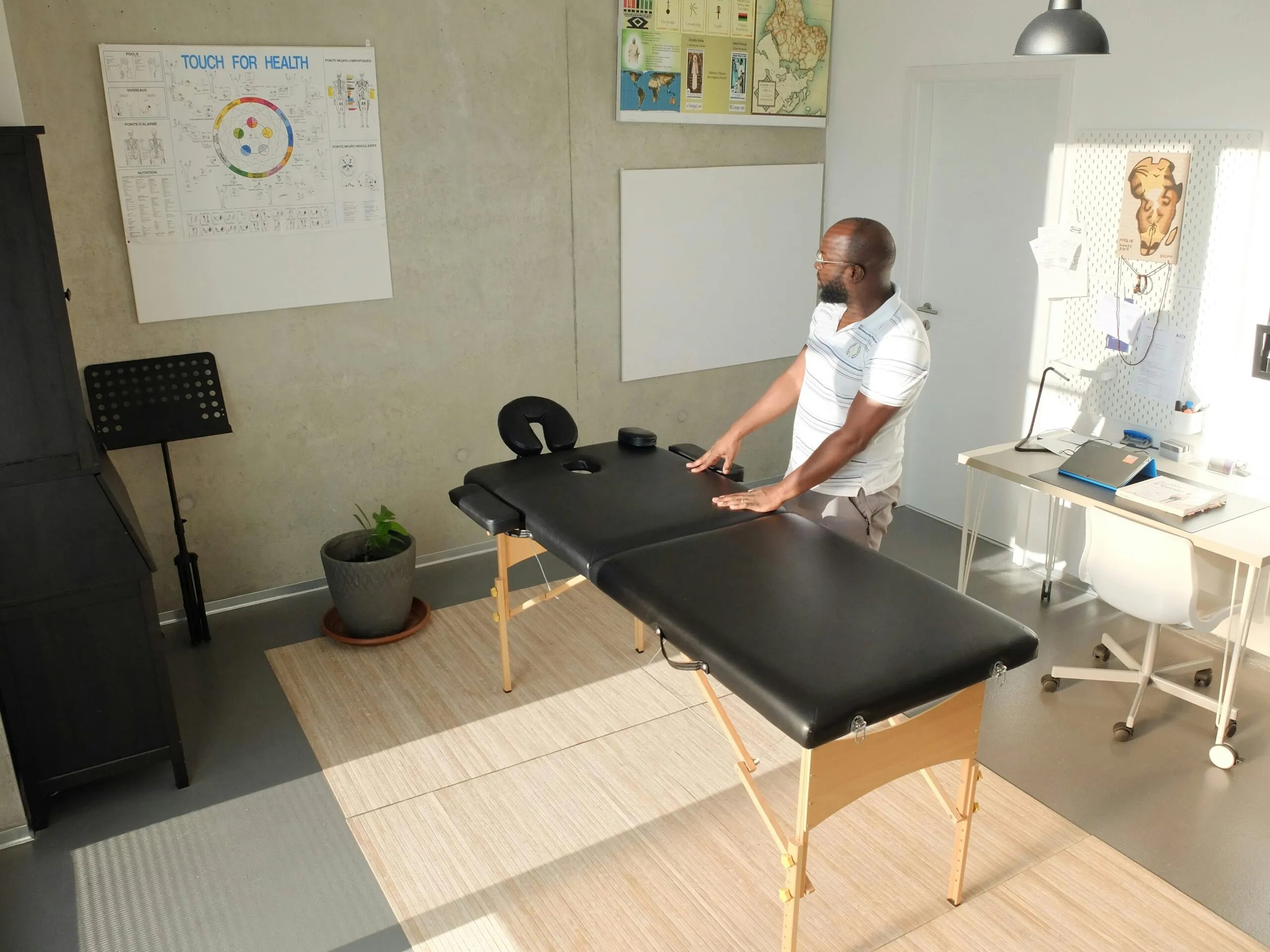 Black Physiotherapist in Examination Room