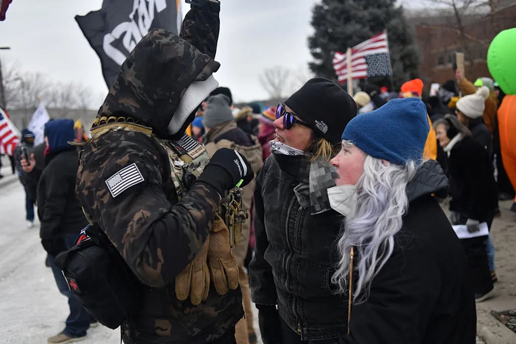 Protesters (R) are confronted by an ICE supporter during a demonstration outside the Bishop Whipple Federal Building in Minneapolis, Minnesota, on January 15, 2026. Hundreds more federal agents were heading to Minneapolis, the US homeland security chief said on January 11, brushing aside demands by the Midwestern city's Democratic leaders to leave after an immigration officer fatally shot a woman protester. In multiple TV interviews, US Homeland Secretary Kristi Noem defended the actions of the officer who shot and killed 37-year-old Renee Nicole Good, whose death has sparked renewed protests nationwide against President Donald Trump's immigration crackdown.