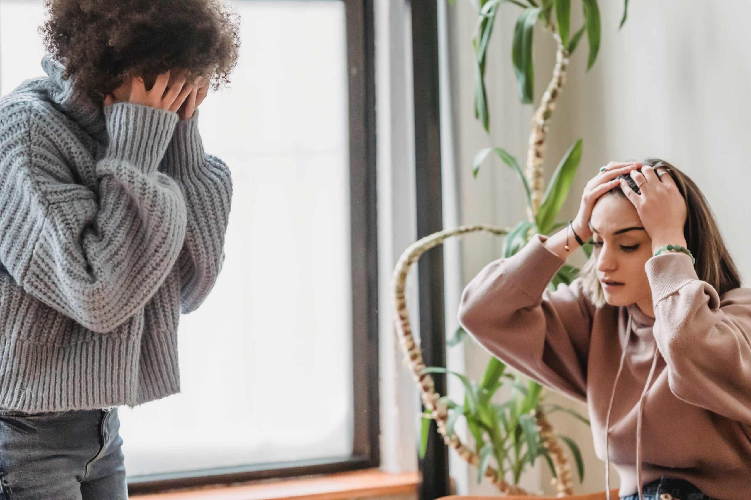 Two women who look to be arguing or fed up with one another. "I statements" are a powerful way of self-expression that may help communication in times like this.