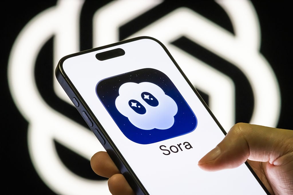 Smartphone screen shows the Sora 2 app icon developed by OpenAI