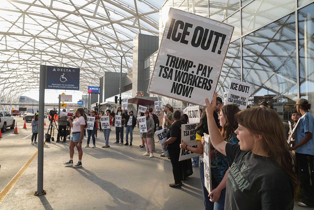 ATLANTA, GEORGIA - MARCH 23: Demonstrators protest against ICE at Atlanta Hartsfield-Jackson International Airport on March 23, 2026 in Atlanta, Georgia.The travel disruptions continue as hundreds of TSA agents quit or work without pay during a partial government shutdown. U.S. President Donald Trump said ICE agents will be deployed to U.S. airports on Monday, with border czar Tom Homan in charge of the effort.
