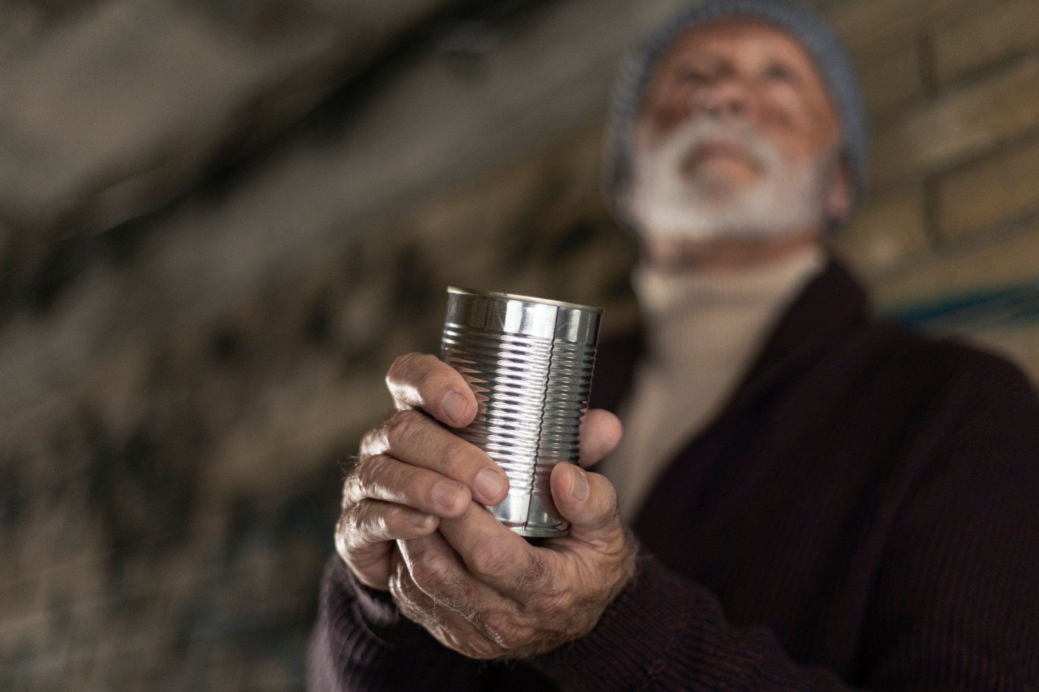 Senior homeless man begging on the street. About 70 years old, Caucasian male.
