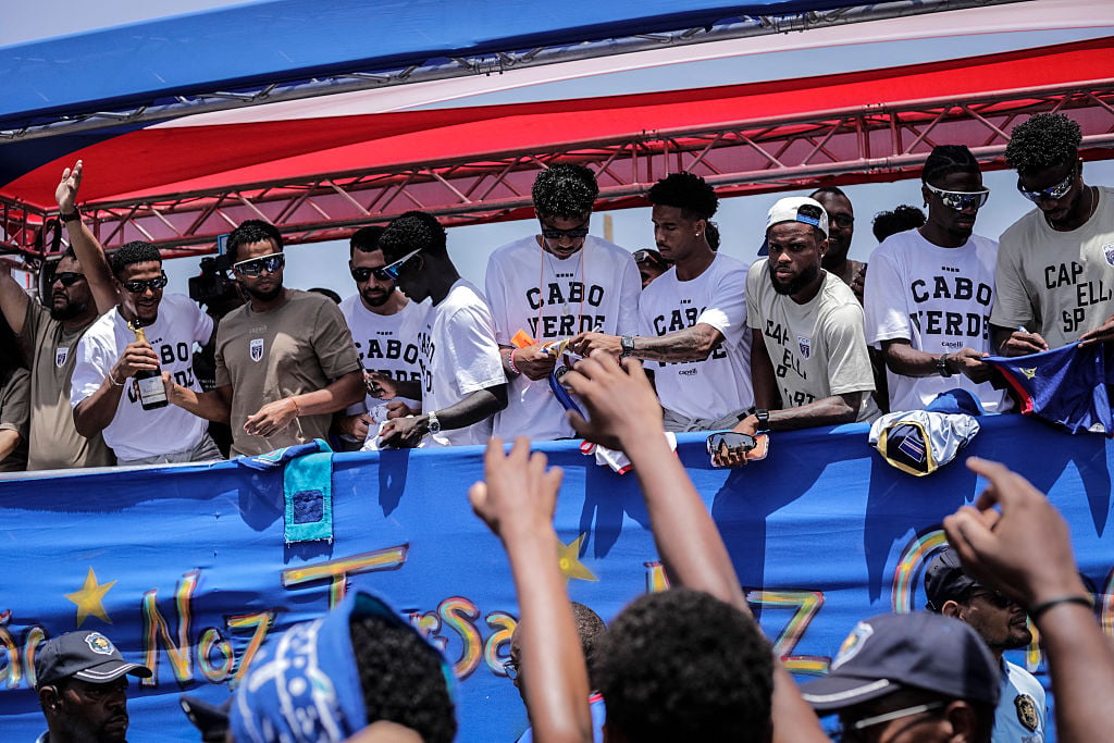 Cape Verde national football team players greet supporters from a bus upon their arrival in Praia on July 5, 2026, after competing at the 2026 FIFA World Cup.