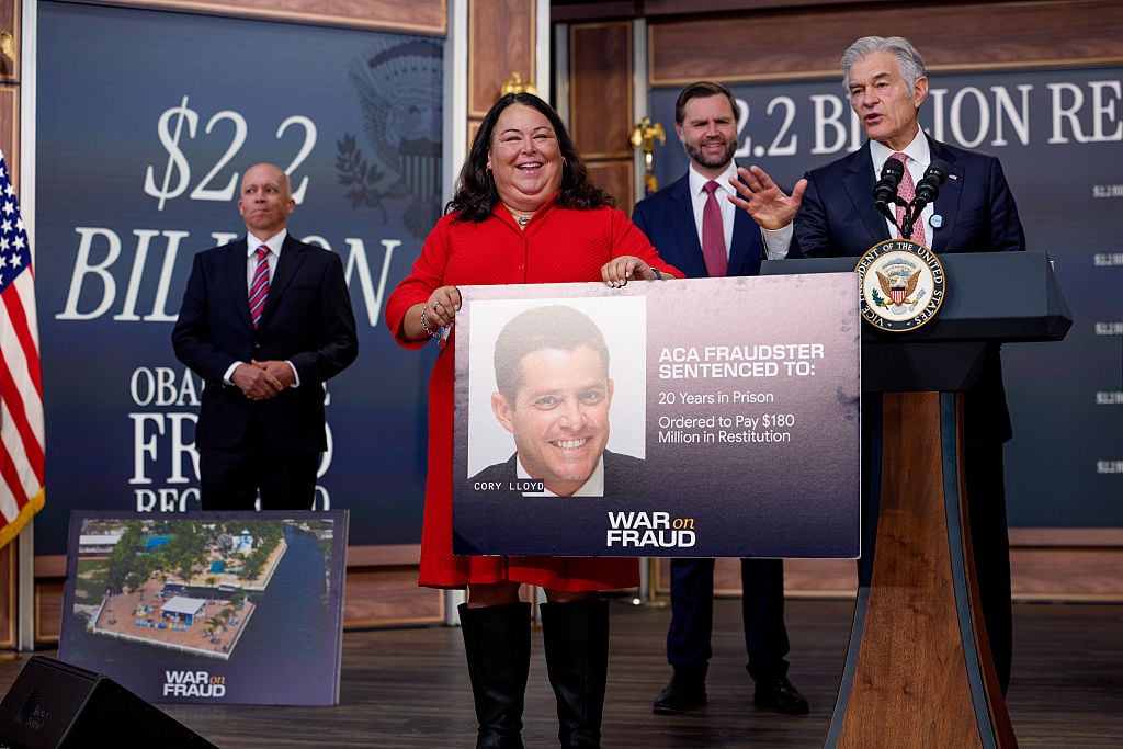 Centers for Medicare &; Medicaid Services Deputy Administrator & Director Peter Nelson (L) and Vice President J.D. Vance (2nd-R) watch as Deputy Administrator & Chief Operating Officer Kimberly Brandt holds up a poster depicting a headshot of Cory Lloyd, convicted of Affordable Care Act fraud, as Administrator for the Centers for Medicare & Medicaid Services Dr. Mehmet Oz (R), accompanied by Vice President J.D. Vance (R), speaks during a news conference on fraud at the Eisenhower Executive Office Building on the White House Campus on September 22, 2026 in Washington, DC. Vance announced a federal crackdown on Affordable Care Act fraud, removing over 750,000 allegedly ineligible enrollments and banning hundreds of suspect brokers to save taxpayers an estimated $2.2 billion.