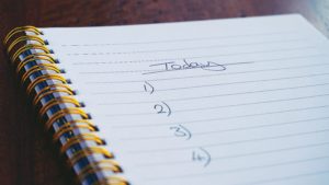 A notepad with a numbered to-do list do the day