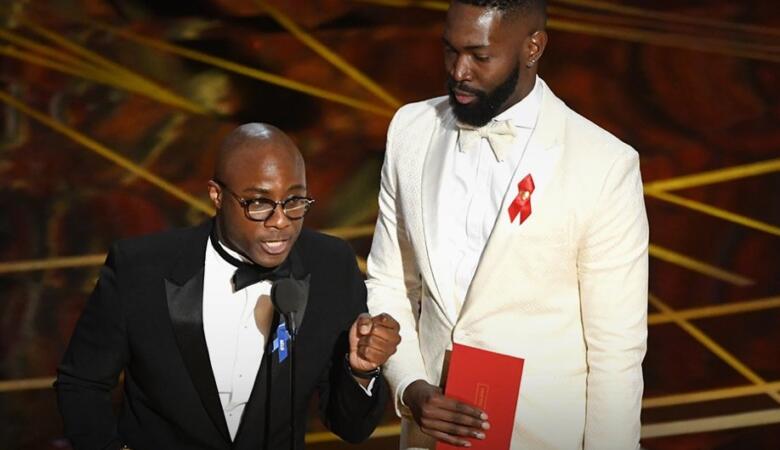Barry Jenkins & Tarell Alvin McCraney accept the award for Best Adapted Screenplay.(Photo by AP)