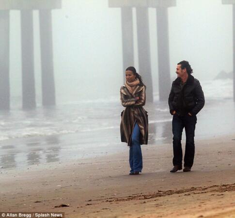 Period piece: The duo seemed to relish donning their 70s outfits and walking on the beach for the upcoming gangster thriller