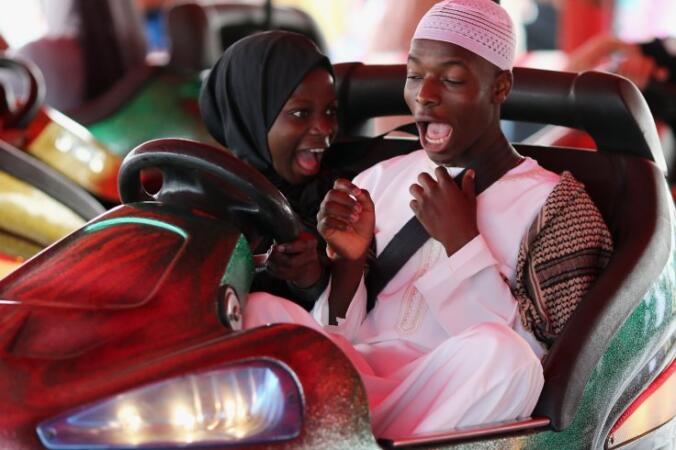 People ride on Bumper cars during an Eid celebration in Burgess Park on July 28, 2014 in London, England