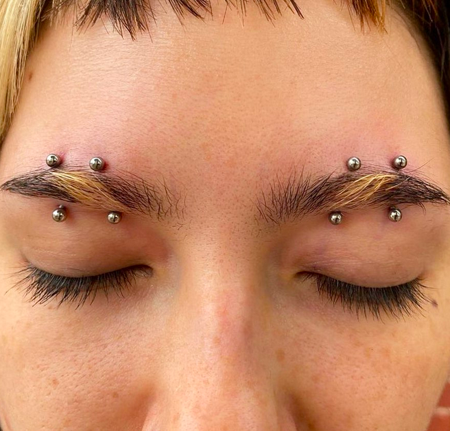 Double orbital piercing over eyelid.