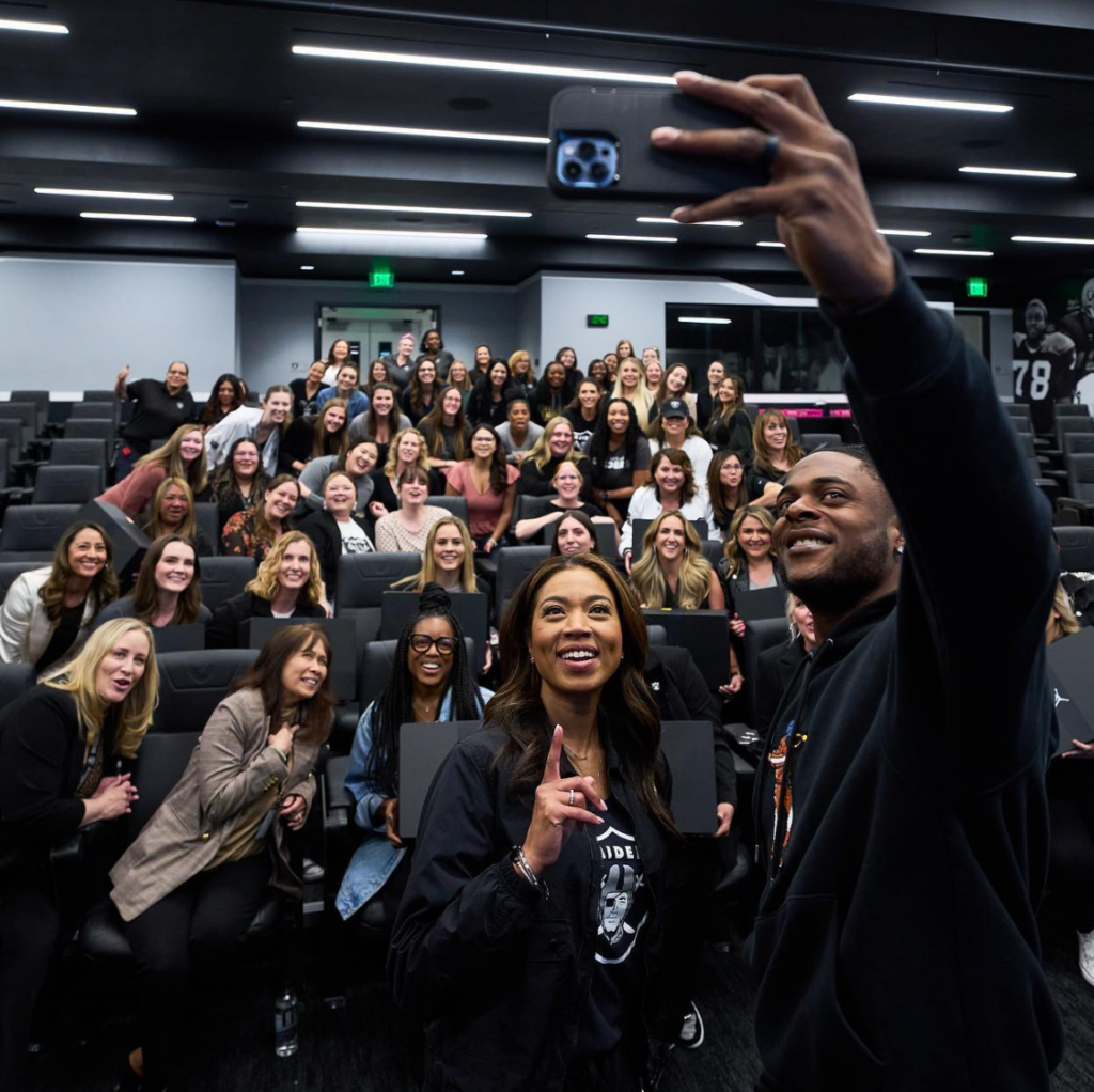 A woman taking a selfie with a large group