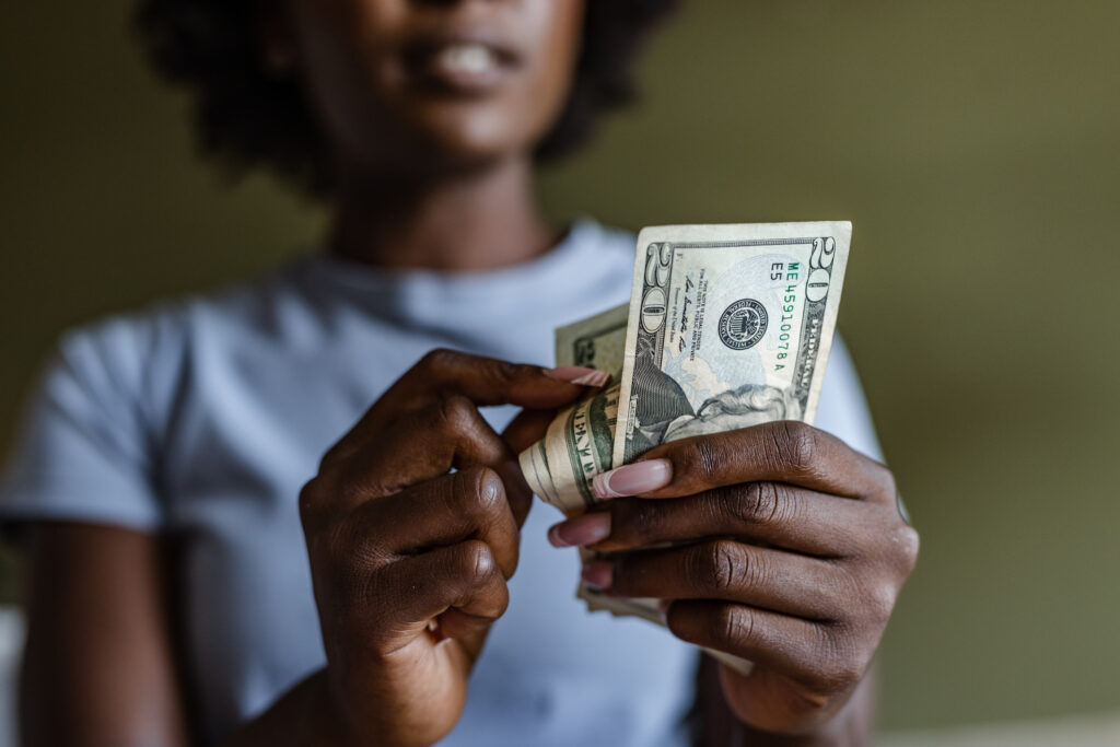 Black woman counting money in her hands