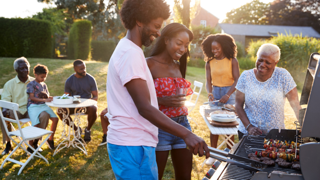 Cheap Date Ideas Couple Grilling at a Black Multi Generation Family Barbecue