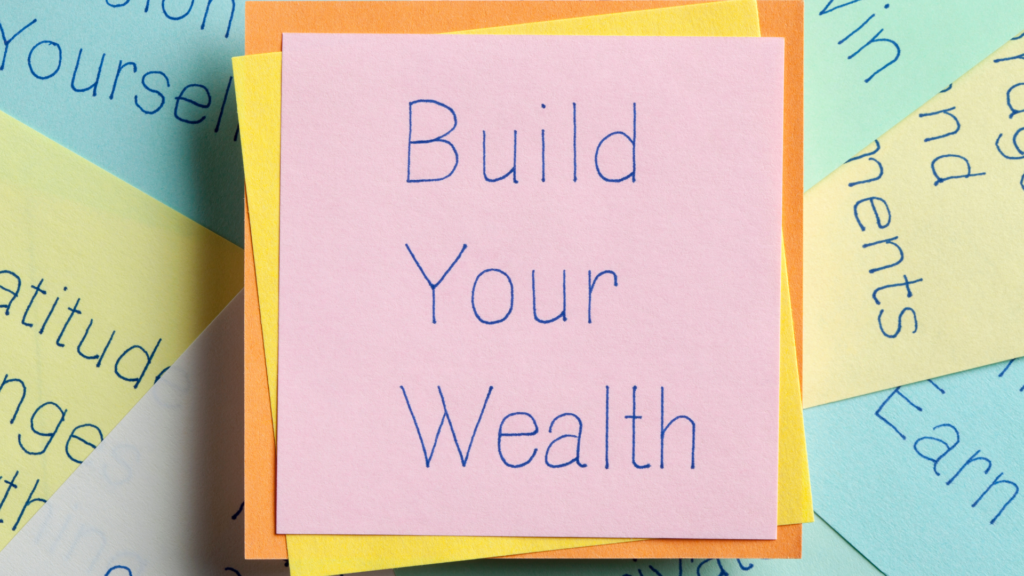 Build Your Wealth written on a sticky note surrounded by other motivational quotes