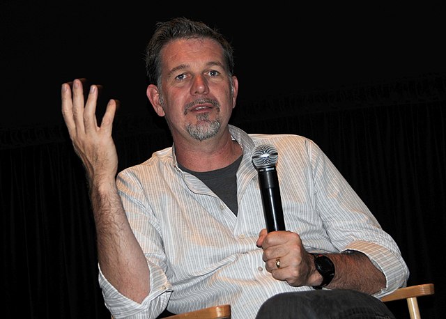 Reed Hastings speaks into a microphone at The Conversation: The Future of Cinema, Games & Online Video, located at UC Berkeley