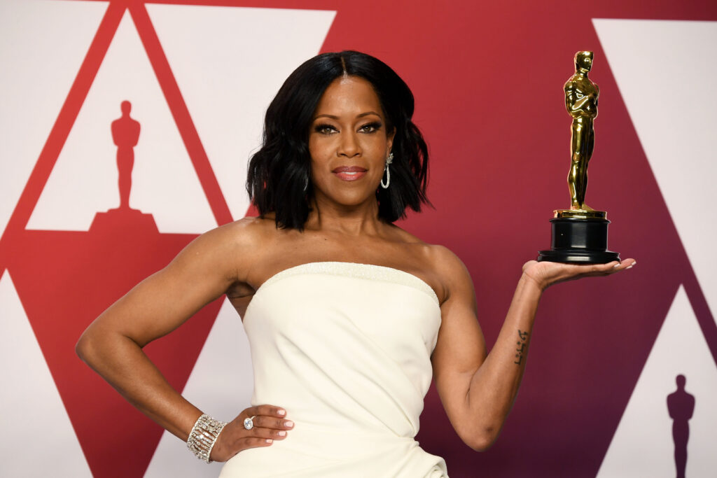 Actor Regina King, winner of the Best Actress in a Supporting Role award for “If Beale Street Could Talk,” poses in the press room with a white dres and award in her palm during at Hollywood and Highland on February 24, 2019 in Hollywood, California.