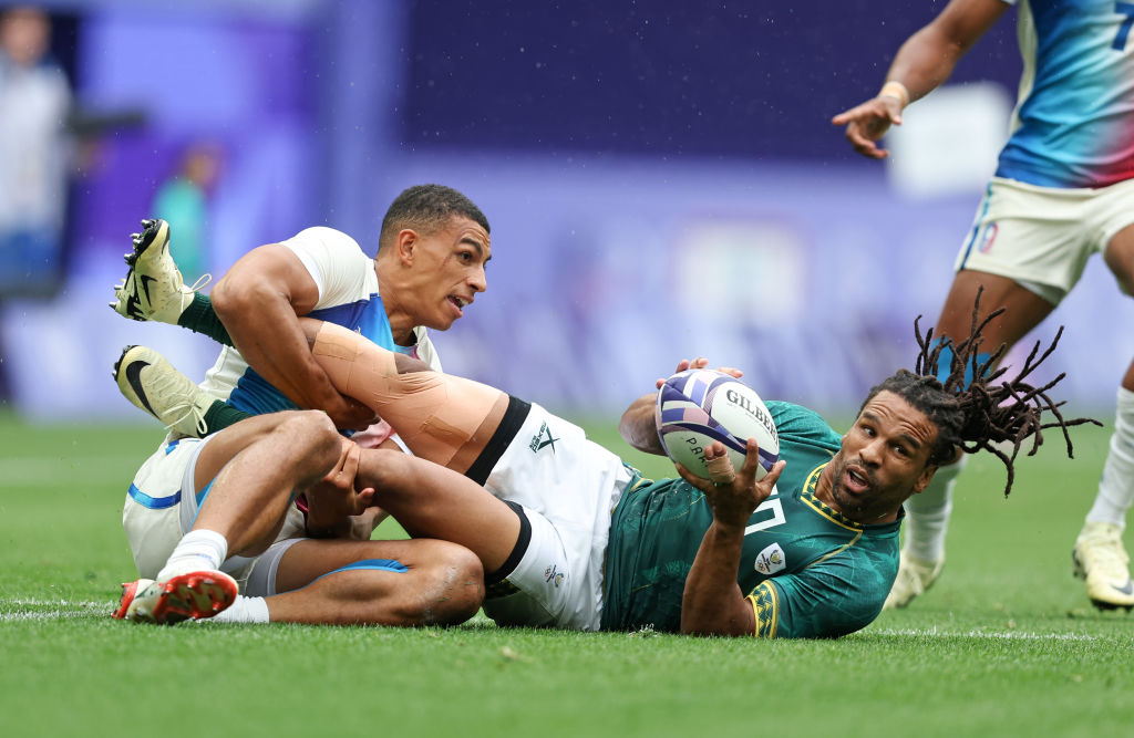 Aaron Grandidier Nkanang of Team France tackles Rosko Specman of Team South Akfrica during Men’s Rugby Sevens Men's Semi-final match between South Africa and France on day one of the Olympic Games Paris 2024 at Stade de France on July 27, 2024 in Paris, France