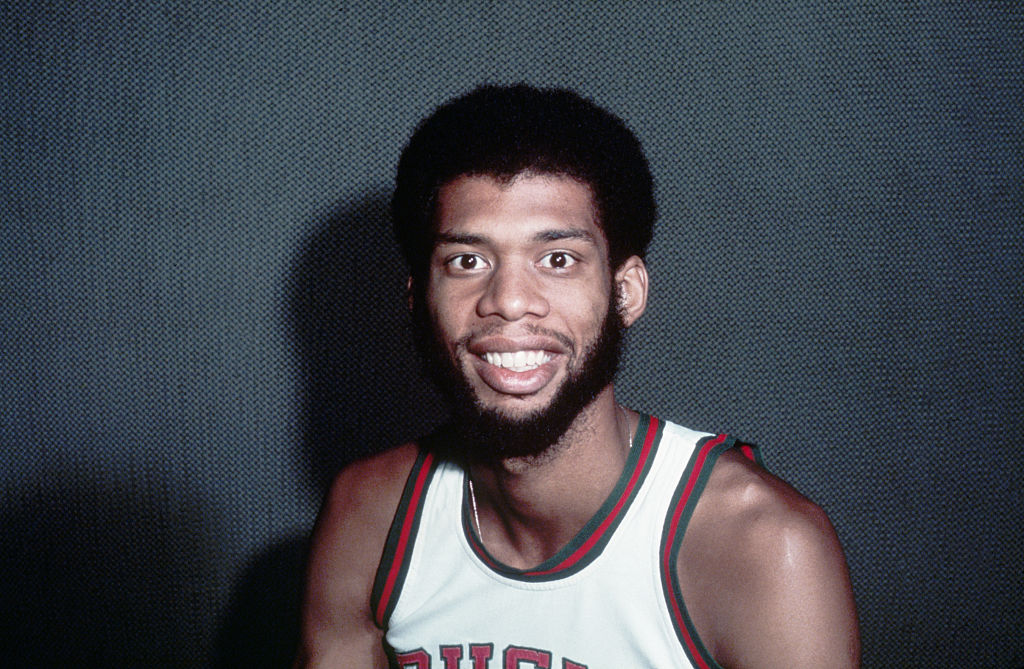 1974 - Close-up of Milwaukee Bucks basketball player Kareem Abdul-Jabbar smiling in his uniform. Color foil.