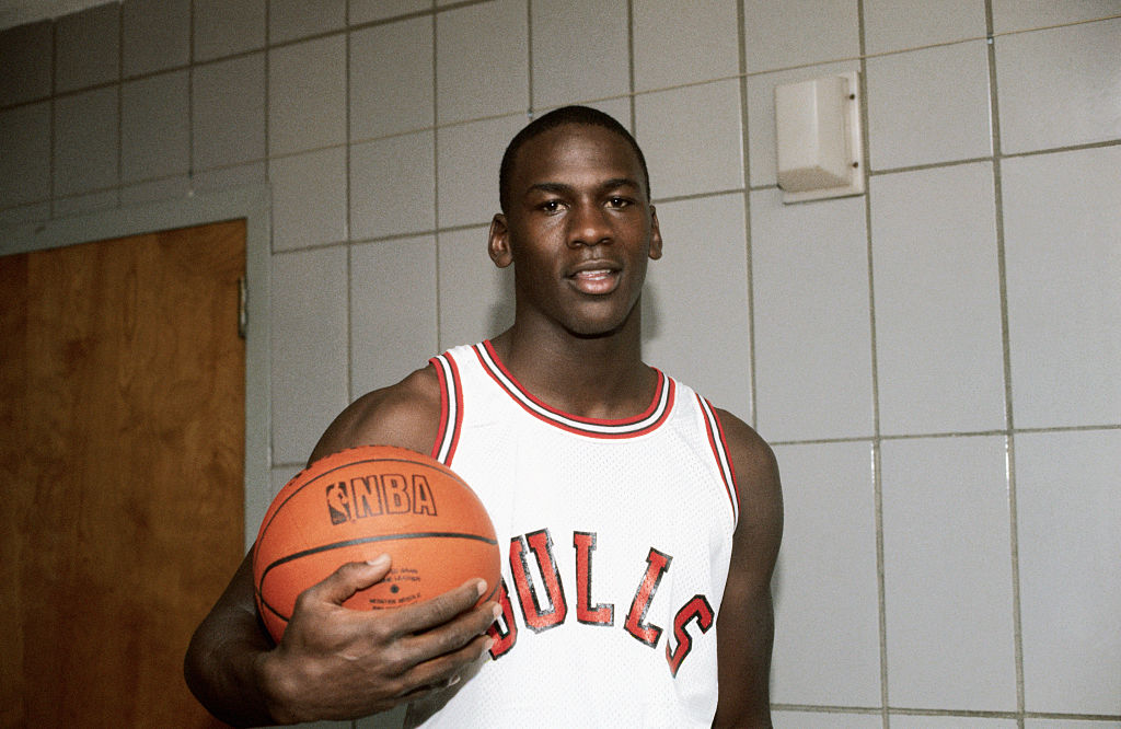 (Original caption) Chicago Bulls forward Michael Jordan holds a basketball in the locker room.