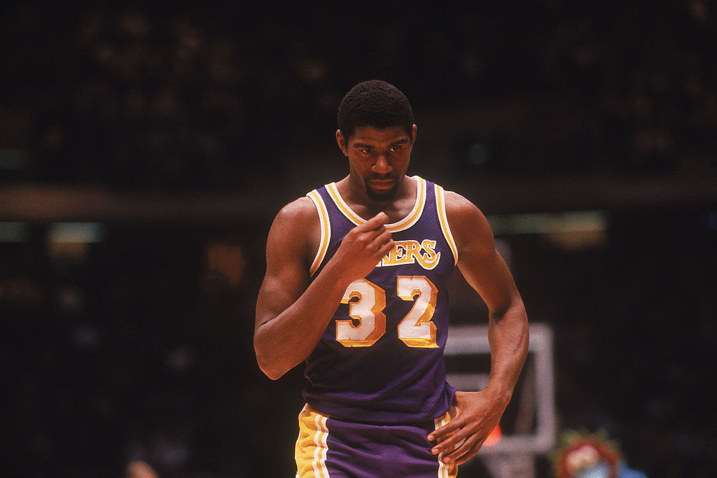 Center Magic Johnson #32 of the Los Angeles Lakers walks on the court circa the 1980's during a game against the Philadelphia Sixers. 