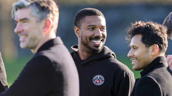 Michael B. Jordan watches from the sidelines during a training session at Vitality Stadium in Bournemouth, England