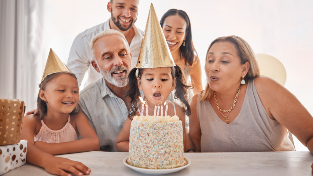 girl birthday cake and candles for happy family at party celebrating in home together