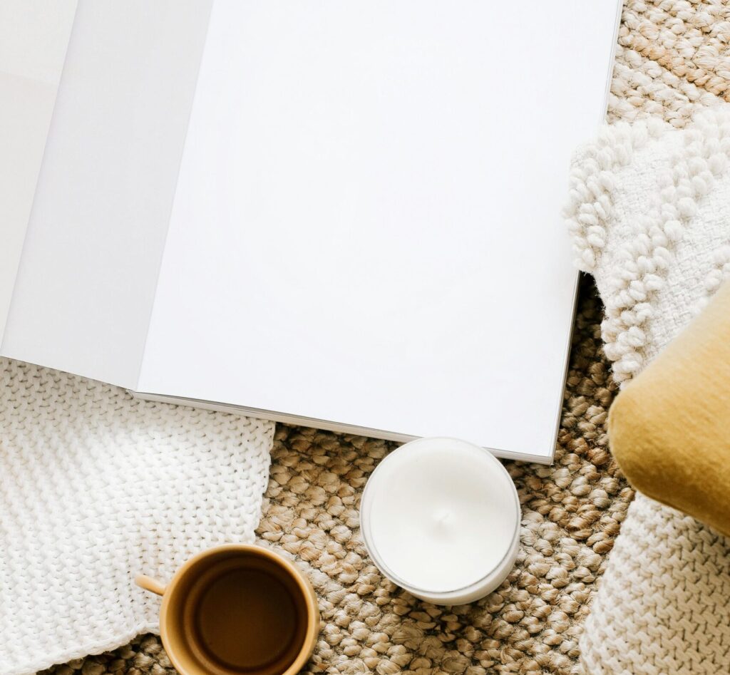 a notebook setup with a candle to the side
