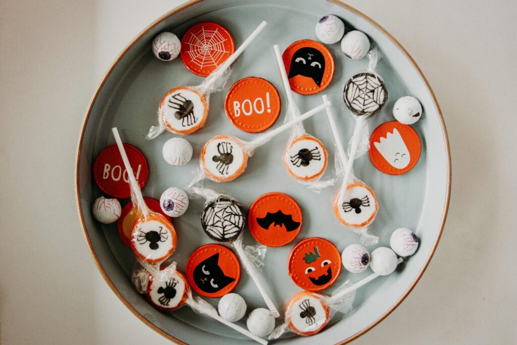 a bowl of Halloween candy with Halloween themed wrappers