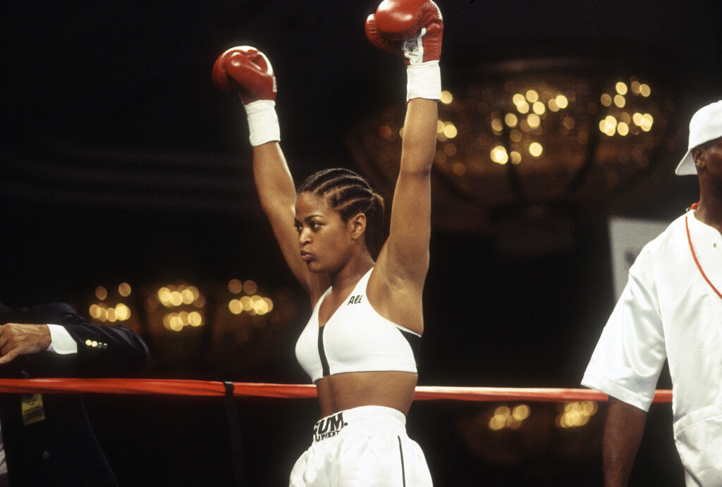 Female middleweight boxers Laila Ali raise her hands after defeating Karen Bill in a boxing match
