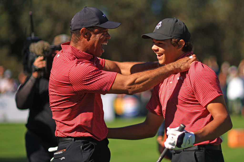 Tiger Woods of the United States reacts with his son Charlie Woods after making the first hole-in-one of his career on the fourth hole during the second round of the PNC Championship at Ritz-Carlton Golf Club on December 22, 2024 in Orlando, Florida.