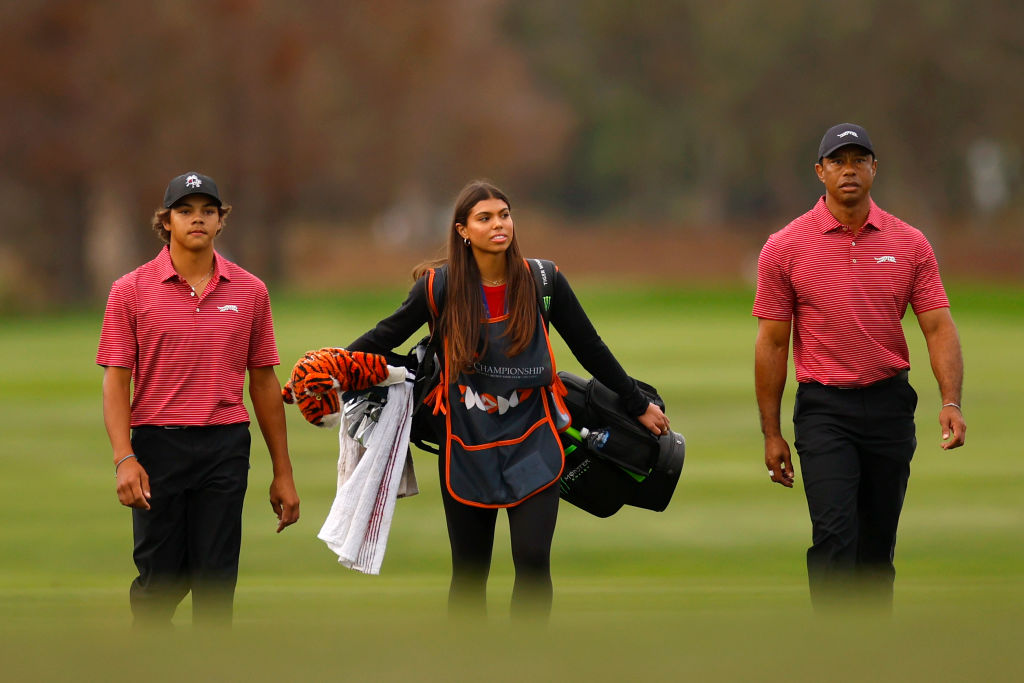 Tiger Woods of the United States with his son Charlie Woods and daughter Sam Woods walk on the 18th hole during the second round of the PNC Championship at Ritz-Carlton Golf Club on December 22, 2024 in Orlando, Florida.