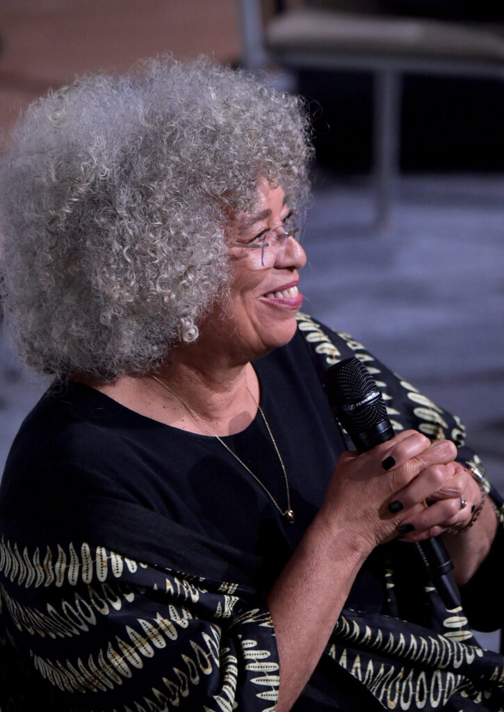 Activist Angela Davis holding a mic