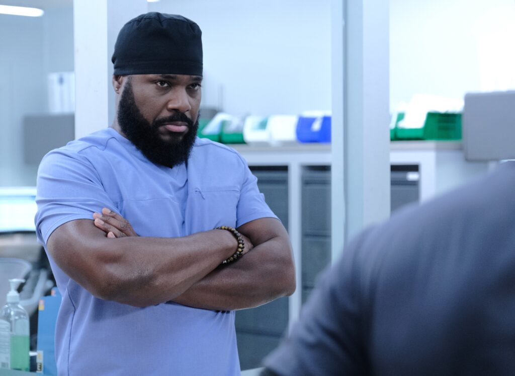 Malcolm-Jamal Warner stands in surgeon attire during the "Woman Down" episode of the TV show "The Resident."