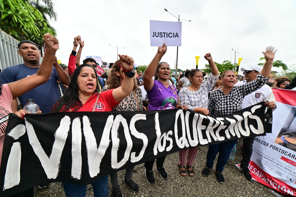 People demonstrate against the disappearance of four minors who went missing during a military operation, outside the courthouse in Guayaquil, Ecuador, on December 31, 2024, during the arraignment hearing against 16 military personnel allegedly involved in the disappearance