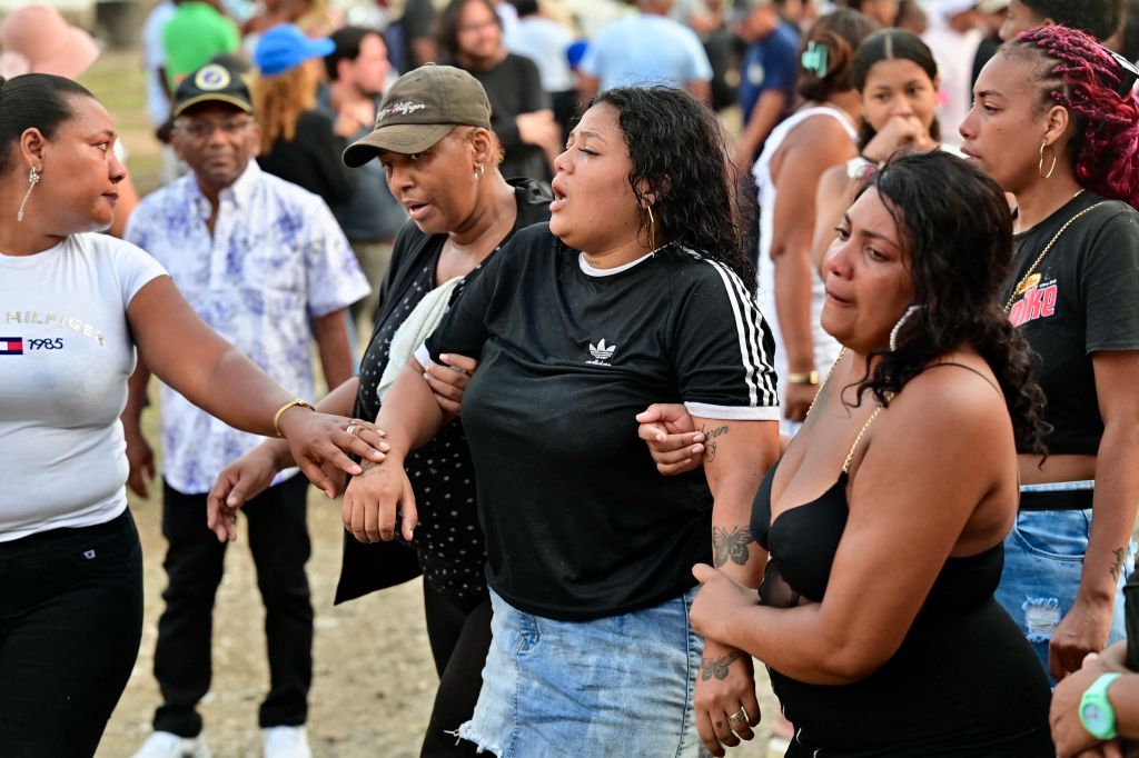 Relatives and friends of siblings Josue and Ismael Arroyo, 14 and 15, respectively, two of the four minors who disappeared during a military operation while playing football, mourn during their burial at the Angel Maria Canals cemetery in Guayaquil, Ecuador, on January 1, 2025. The four Ecuadorian teenagers apprehended by soldiers and found dead near a military base were buried on Wednesday in the port of Guayaquil, amid outrage over the event that mourns the country, according to the government.