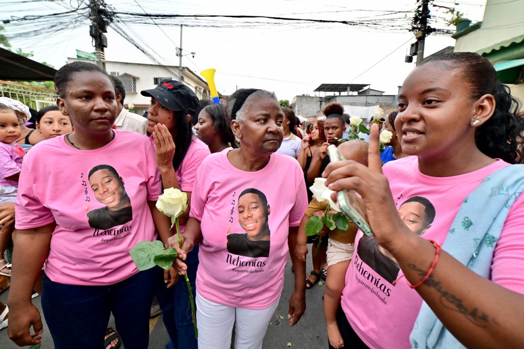 Women wearing shirts with the picture of Nehemias Arboleda, one of the four Ecuadorian teenagers apprehended by soldiers and found dead near a military base, attend a march one month after their apprehension in Guayaquil, Ecuador on January 8, 2025.