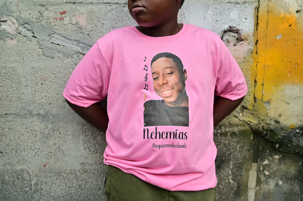 A boy wearing a shirt with the picture of Nehemias Arboleda, one of the four Ecuadorian teenagers apprehended by soldiers and found dead near a military base, attends a march one month after their apprehension in Guayaquil, Ecuador on January 8, 2025.