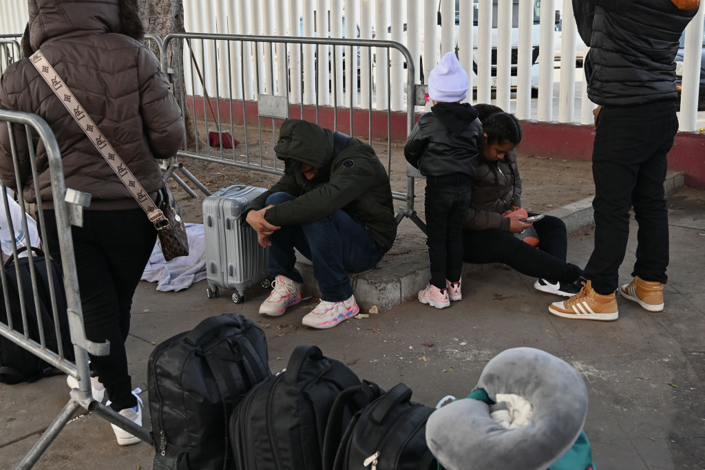 Asylum seekers wait for their CBP One appointments before crossing through El Chaparral border port in Tijuana, Mexico, on January 20, 2025. The Trump administration shuts down the CBP One app for migrants. The Biden-era process allows nearly 1 million migrants to enter the US at legal border crossings since the app initiates. It is estimated that 270,000 migrants wait in Mexico, hoping to use the app to enter the US.