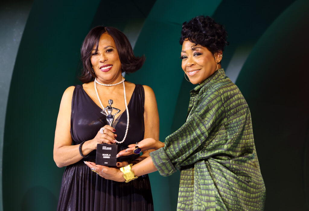 LOS ANGELES, CALIFORNIA - FEBRUARY 27: (L-R) Angela Gibbs and Tichina Arnold pose onstage with Honoree Marla Gibbs' award during the 2025 ESSENCE Black Women In Hollywood Awards at Fairmont Century Plaza on February 27, 2025 in Los Angeles, California. (Photo by Leon Bennett/Getty Images for ESSENCE)