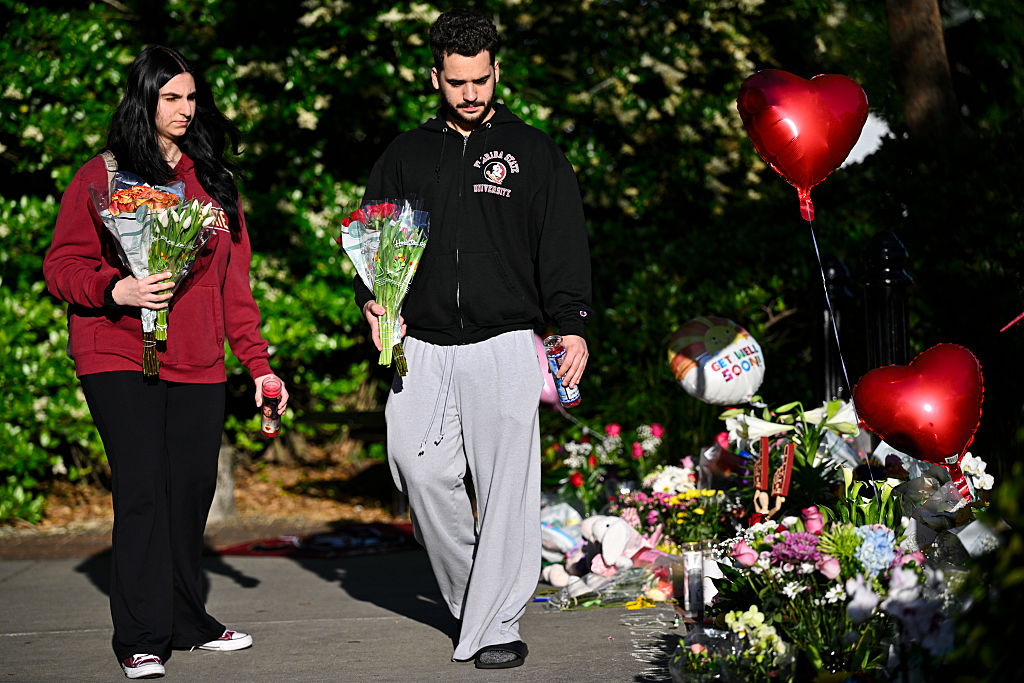 TALLAHASSEE, FLORIDA - APRIL 18: Students honor the deceased and injured students near the scene of a shooting at the Florida State University student center on April 18, 2025 in Tallahassee, Florida. Two people were reported dead and several others injured when the suspected shooter, believed to be a student and the son of a Leon County Sheriff's deputy, opened fire on the university's main campus.