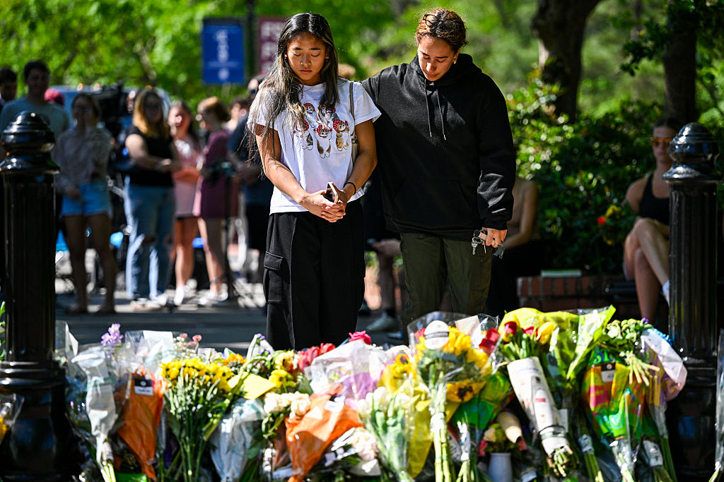 TALLAHASSEE, FLORIDA - APRIL 18: Students honor the deceased and injured students near the scene of a shooting near the Florida State University student center on April 18, 2025 in Tallahassee,Florida. Two people were reported dead and several others injured when the suspected shooter, believed to be a student and the son of a Leon County Sheriff deputy, opened fire on the university's main campus.