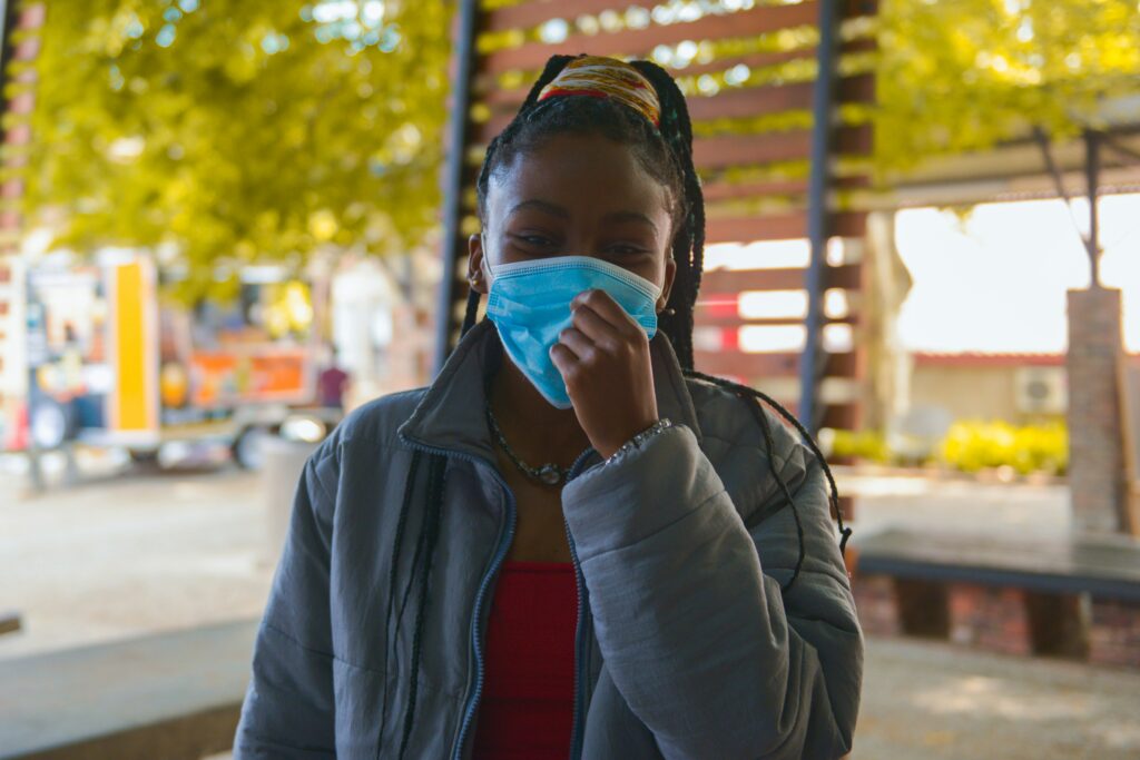 how to cure a sinus infection naturally pictured: woman wearing a mask
