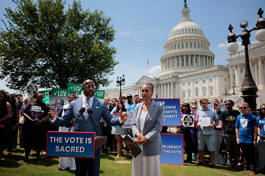 WASHINGTON, DC - JULY 29: Sen. Raphael Warnock (D-GA) and Maya Wiley, president and CEO of the Leadership Conference on Civil and Human Rights, join civil rights and voting rights advocates to reintroduce the John R. Lewis Voting Rights Advancement Act outside the U.S. Capitol on July 29, 2025 in Washington, DC. Sixty years after the late Rep. John Lewis (D-GA) was violently attacked crossing the Edmund Pettus Bridge in Selma, Alabama, the legislation that bears his name would restore and strengthen parts of the Voting Rights Act of 1965, including the requirement for states and jurisdictions with a history of voting rights violations to seek federal approval before enacting certain changes to their voting laws.
