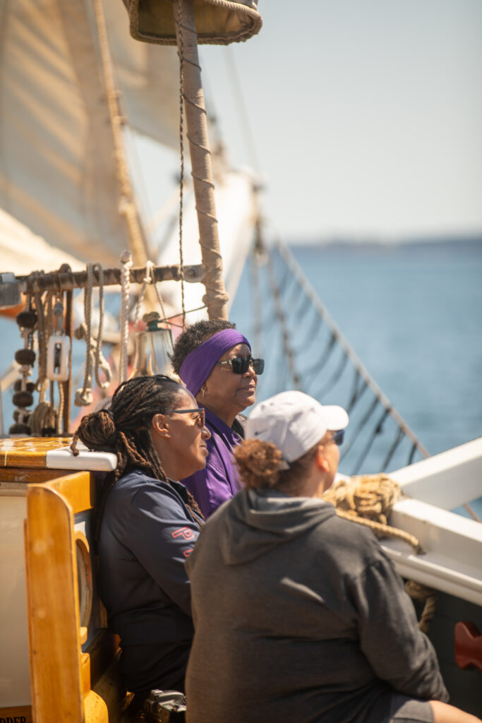 (L to R) Idella Glenn, Ellen McKenzie, and Rachel Morales aboard the Lewis R. French sailing across Maine